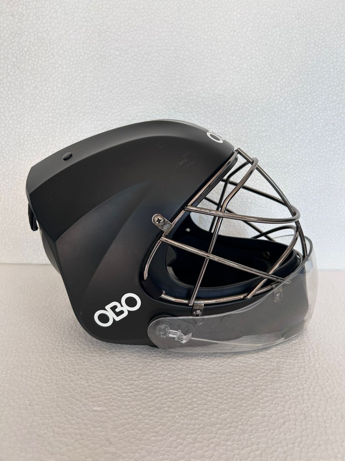 OBO ABS Large black field hockey goalkeeper helmet with silver face cage and clear throat protector